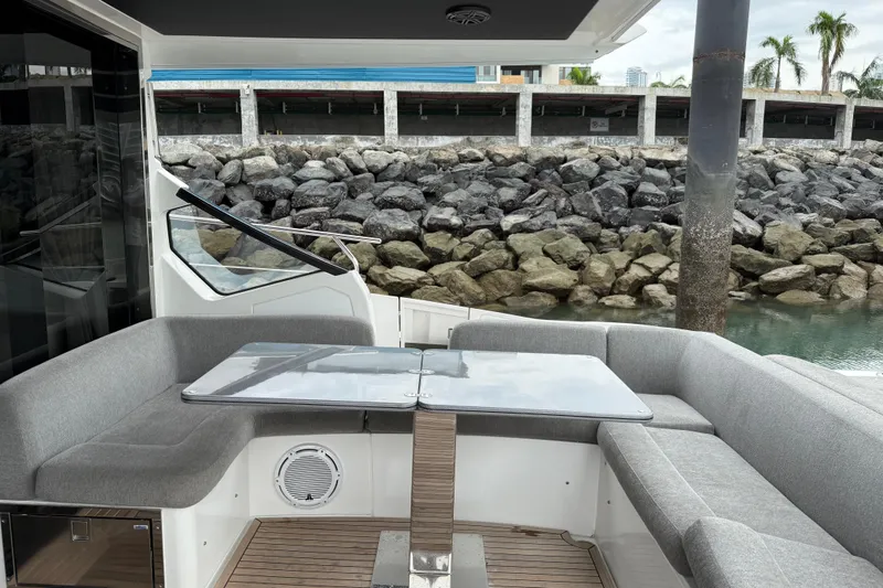  Yacht Photos Pics Luxurious 2019 Azimut S6 yacht with elegant outdoor seating and table by the water.