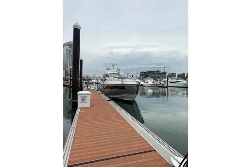  Yacht Photos Pics 2019 Azimut S6 yacht docked at a marina, surrounded by calm waters and cityscape.