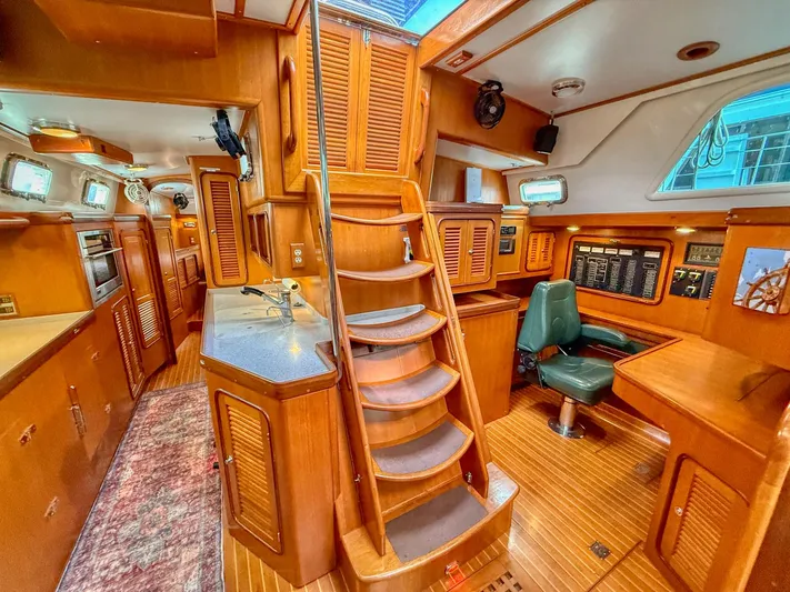 Bluepearl Yacht Photos Pics Luxurious interior of 2006 Passport Vista 515CC yacht with wooden finishes and navigation station.