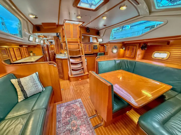 Bluepearl Yacht Photos Pics Luxurious interior of 2006 Passport Vista 515CC yacht with wooden finishes and plush seating.