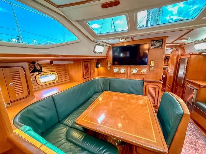 Bluepearl Yacht Photos Pics Luxurious interior of 2006 Passport Vista 515CC yacht with wood finish and seating area.