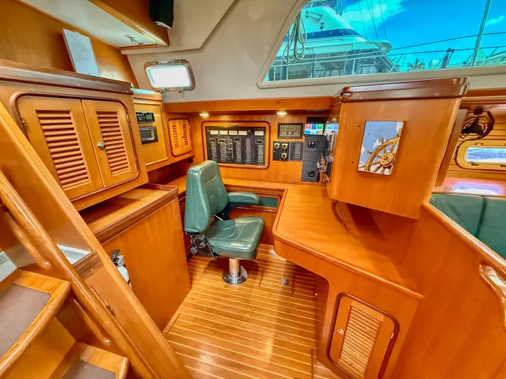 Bluepearl Yacht Photos Pics Interior of 2006 Passport Vista 515CC yacht with wooden cabinetry and navigation station.
