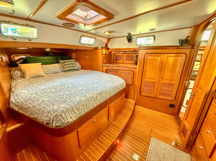 Bluepearl Yacht Photos Pics Luxurious cabin interior of 2006 Passport Vista 515CC yacht with wooden finishes.