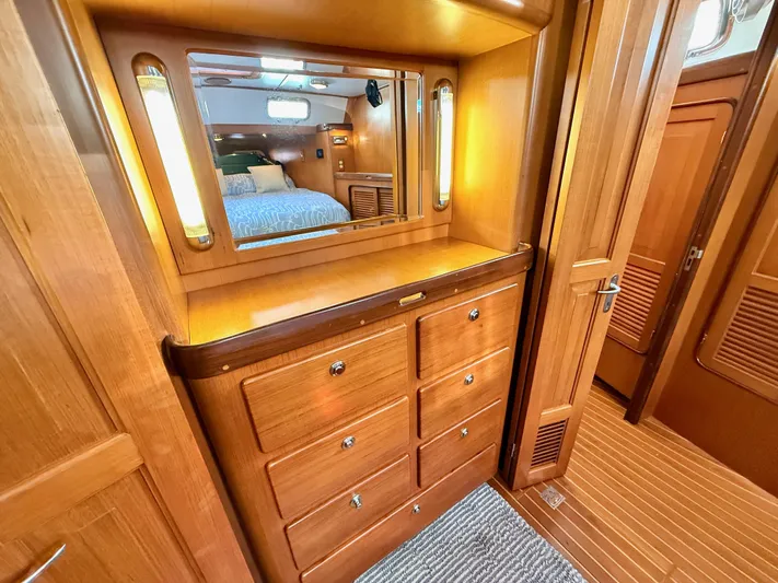 Bluepearl Yacht Photos Pics Luxurious wooden interior of 2006 Passport Vista 515CC yacht with mirror and drawers.