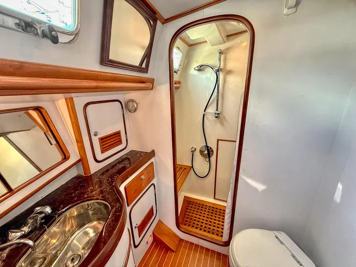 Bluepearl Yacht Photos Pics Luxurious bathroom in 2006 Passport Vista 515CC yacht with shower, sink, and toilet.