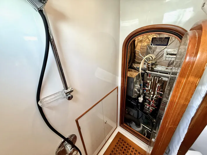 Bluepearl Yacht Photos Pics Shower area in 2006 Passport Vista 515CC yacht with visible plumbing and wooden accents.