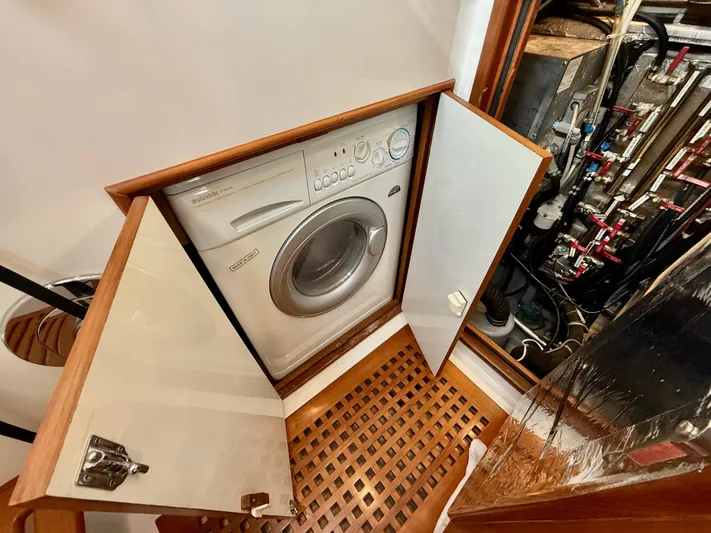 Bluepearl Yacht Photos Pics Compact laundry area in a 2006 Passport Vista 515CC yacht, featuring a built-in washing machine.