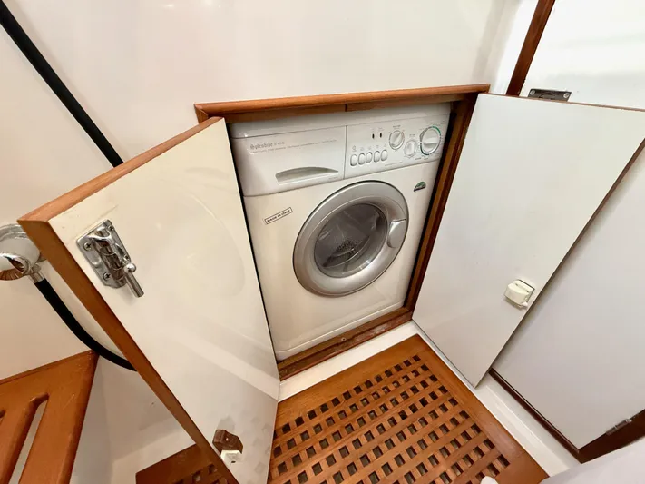 Bluepearl Yacht Photos Pics Compact washing machine in a 2006 Passport Vista 515CC yacht's wooden cabinet.