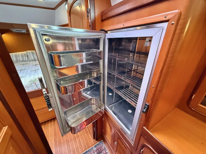 Bluepearl Yacht Photos Pics Open stainless steel refrigerator in 2006 Passport Vista 515CC yacht interior.