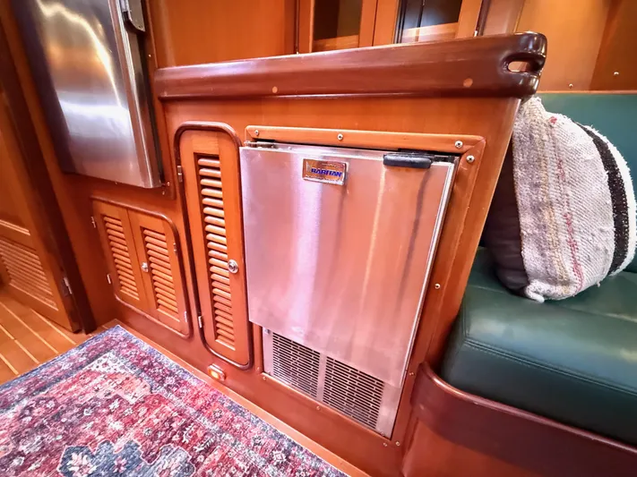 Bluepearl Yacht Photos Pics Interior of 2006 Passport Vista 515CC yacht with stainless steel fridge and wooden cabinetry.