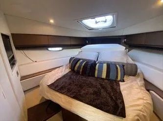 Slipknot Yacht Photos Pics Luxurious cabin interior of 2012 Sea Ray 410 Sundancer yacht with cozy bedding.