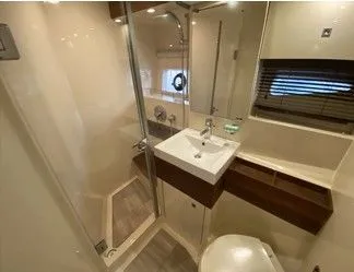 Slipknot Yacht Photos Pics 2012 Sea Ray 410 Sundancer bathroom with modern fixtures and glass shower.