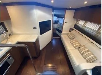 Slipknot Yacht Photos Pics Interior of 2012 Sea Ray 410 Sundancer yacht with modern kitchen and cozy seating area.