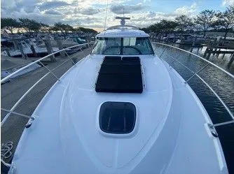 Slipknot Yacht Photos Pics 2012 Sea Ray 410 Sundancer yacht docked at marina under cloudy sky.