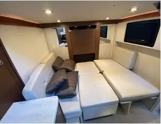 Slipknot Yacht Photos Pics Interior of 2012 Sea Ray 410 Sundancer yacht with white seating and cushions.