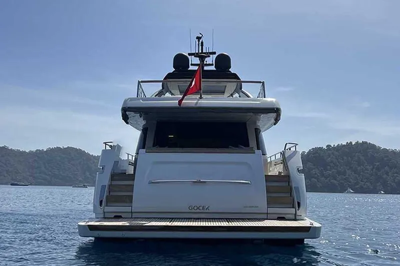  Yacht Photos Pics 2019 Sanlorenzo 86 yacht on calm water, rear view with scenic island backdrop.