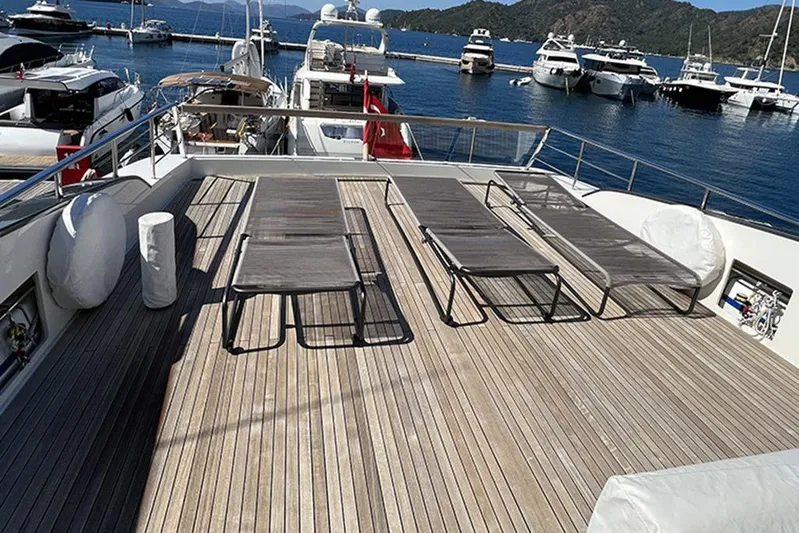  Yacht Photos Pics Luxurious 2019 Sanlorenzo 86 yacht deck with sun loungers, docked in a scenic marina.