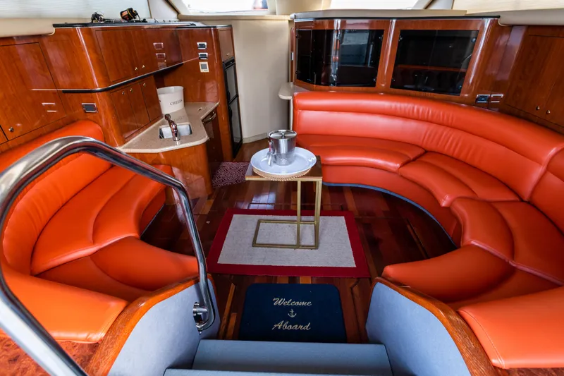  Yacht Photos Pics Luxurious 2003 Sea Ray Express Bridge interior with orange seating and elegant wood finishes.