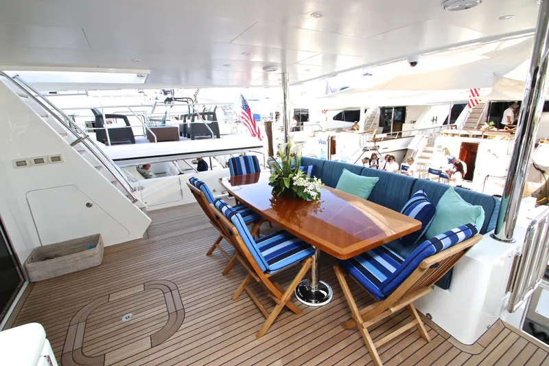 Quit Sun Yacht Photos Pics Luxurious 2015 Hargrave 76 yacht deck with elegant dining area and striped cushions.