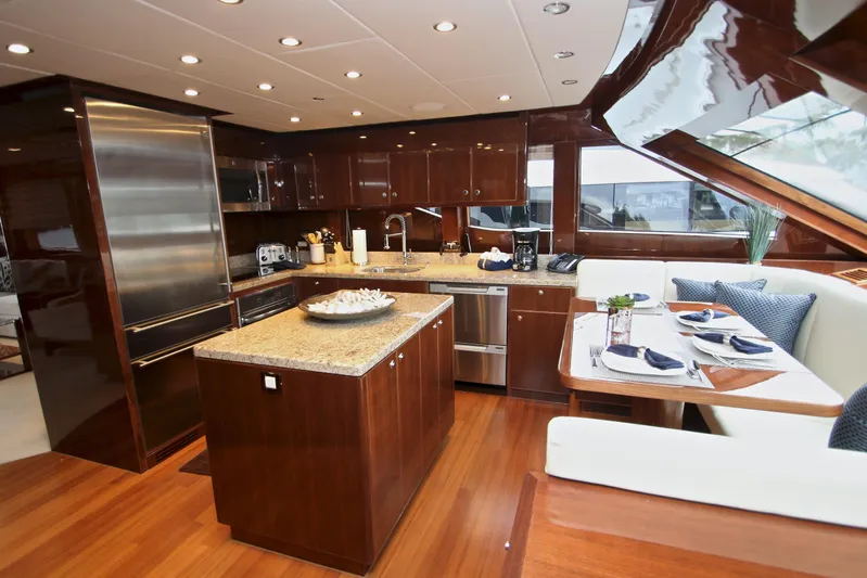 Quit Sun Yacht Photos Pics Luxurious kitchen interior of 2015 Hargrave 76 yacht with elegant wood finishes.