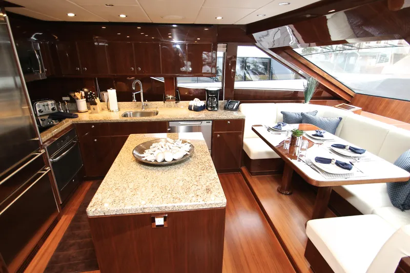 Quit Sun Yacht Photos Pics Luxurious 2015 Hargrave 76 yacht kitchen with granite countertops and elegant dining area.