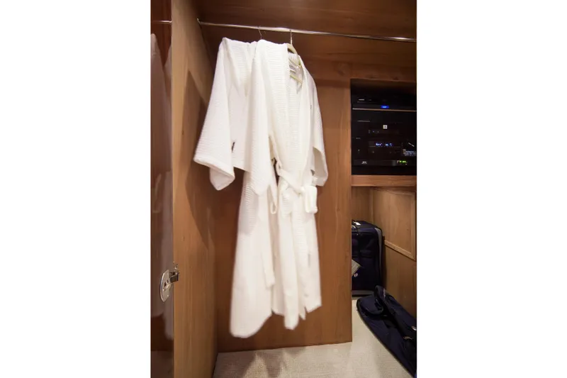 Quit Sun Yacht Photos Pics White bathrobe hanging in a wooden closet on a 2015 Hargrave 76 yacht.