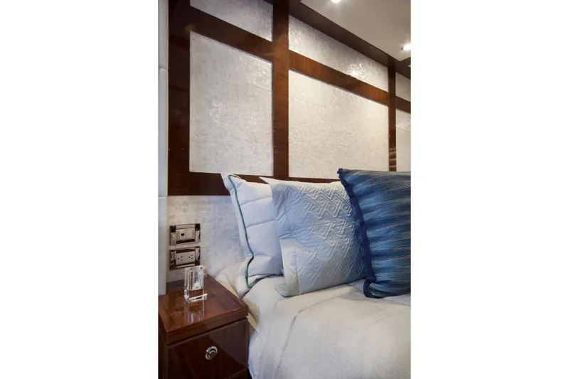 Quit Sun Yacht Photos Pics Luxurious bedroom interior of 2015 Hargrave 76 yacht with elegant pillows and wood accents.