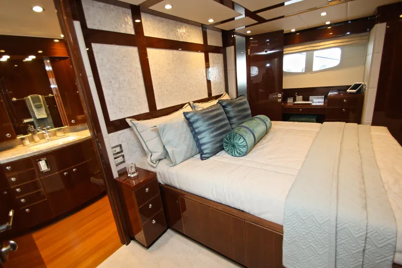 Quit Sun Yacht Photos Pics Luxurious bedroom interior of 2015 Hargrave 76 yacht with elegant wood finishes.