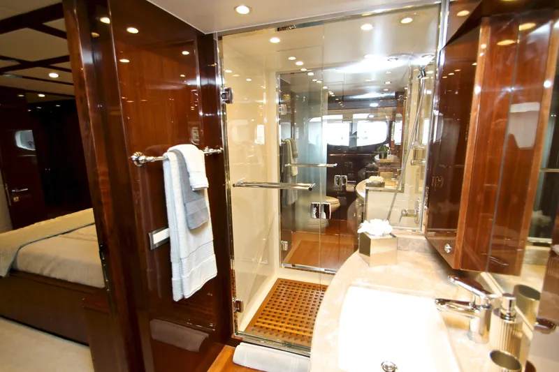 Quit Sun Yacht Photos Pics Luxurious bathroom interior of 2015 Hargrave 76 yacht with glass shower and wooden accents.