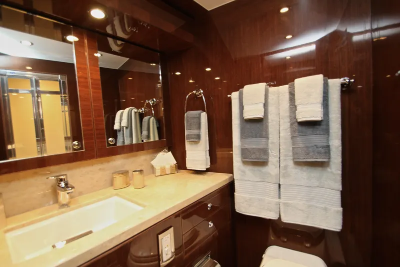 Quit Sun Yacht Photos Pics Luxurious bathroom in 2015 Hargrave 76 yacht with elegant wood paneling and plush towels.