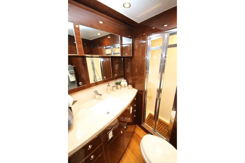 Quit Sun Yacht Photos Pics Luxurious bathroom in 2015 Hargrave 76 yacht with wood accents and modern fixtures.