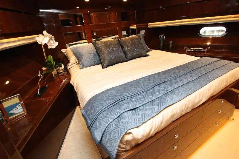 Quit Sun Yacht Photos Pics Luxurious bedroom interior of 2015 Hargrave 76 yacht with elegant bedding and wood finishes.