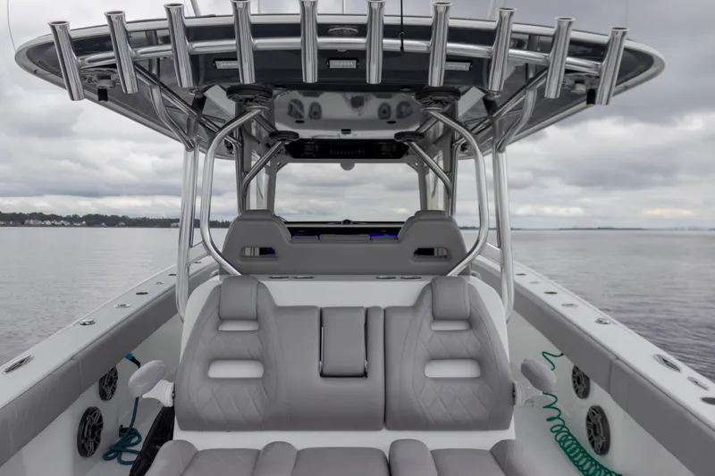  Yacht Photos Pics Freeman 42LR 2020 boat interior with gray seating and rod holders on a cloudy day.