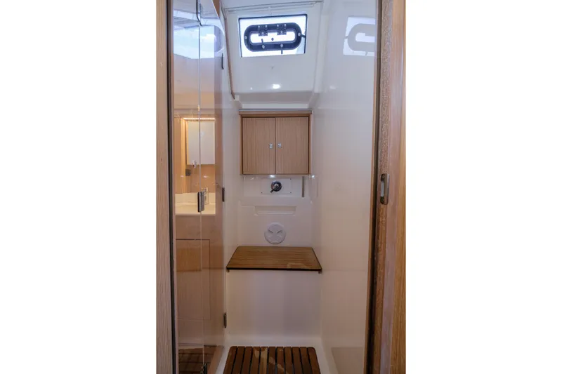  Yacht Photos Pics Interior of 2022 Bavaria C57 yacht bathroom with wooden accents and modern fixtures.