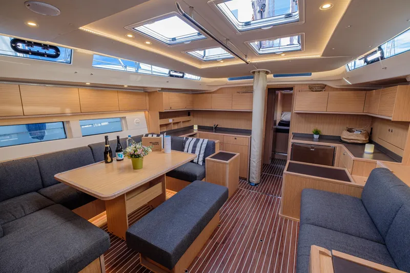  Yacht Photos Pics Luxurious interior of 2022 Bavaria C57 yacht with modern furnishings and ample natural light.