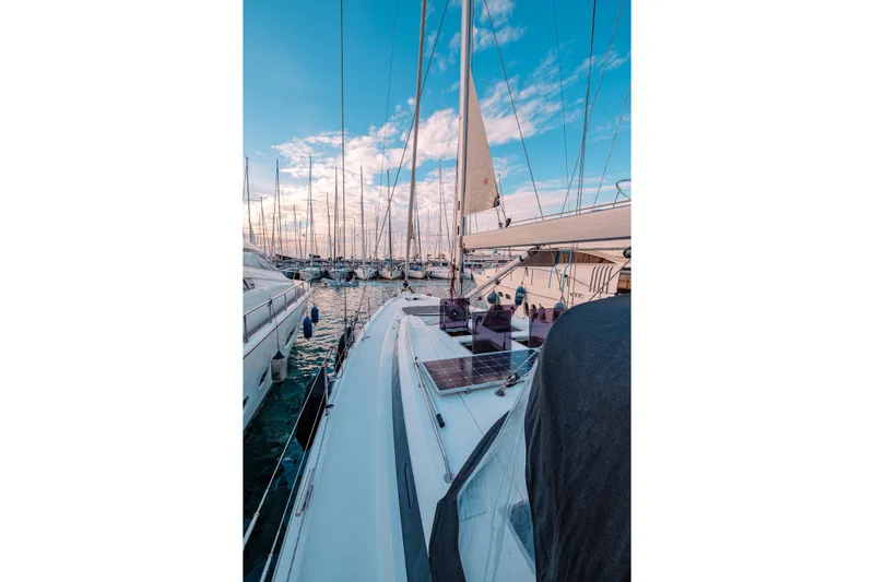  Yacht Photos Pics Sailboats docked at marina, featuring 2022 Bavaria C57 under a vibrant blue sky.