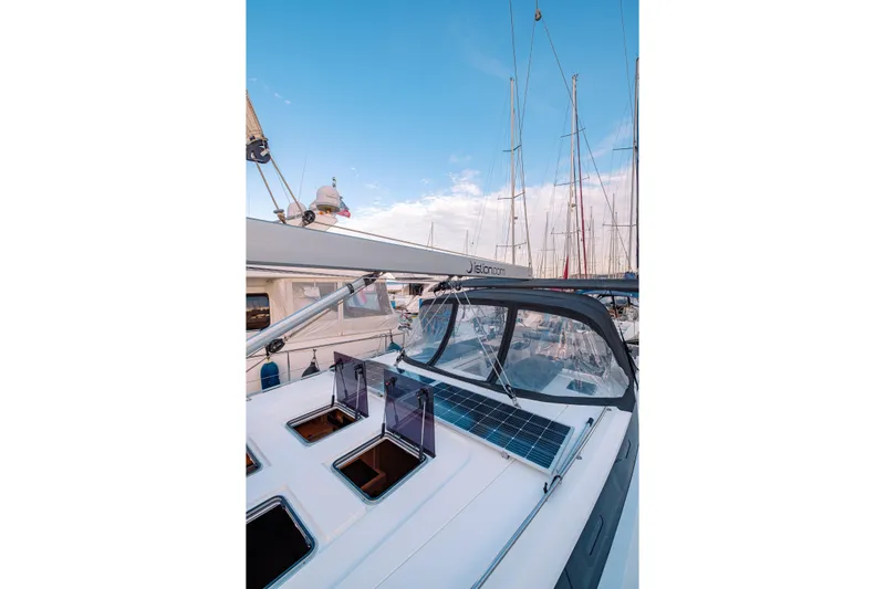  Yacht Photos Pics 2022 Bavaria C57 yacht with solar panels, docked under a clear blue sky.
