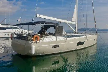  Yacht Photos Pics 2022 Bavaria C57 sailboat on calm water, featuring sleek design and modern amenities.
