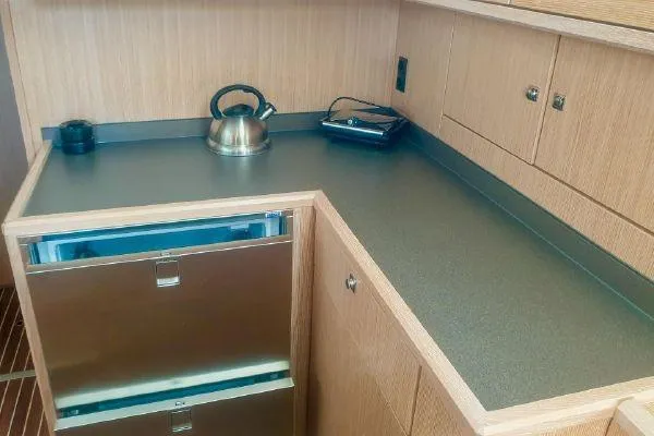  Yacht Photos Pics Modern kitchen area in 2022 Bavaria C57 yacht with stainless steel appliances.
