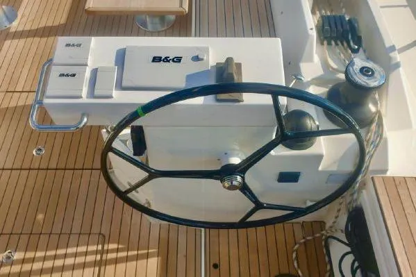  Yacht Photos Pics Steering wheel and controls of a 2022 Bavaria C57 yacht on teak deck.