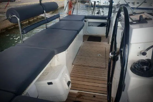  Yacht Photos Pics 2022 Bavaria C57 yacht cockpit with cushioned seating and wooden flooring.