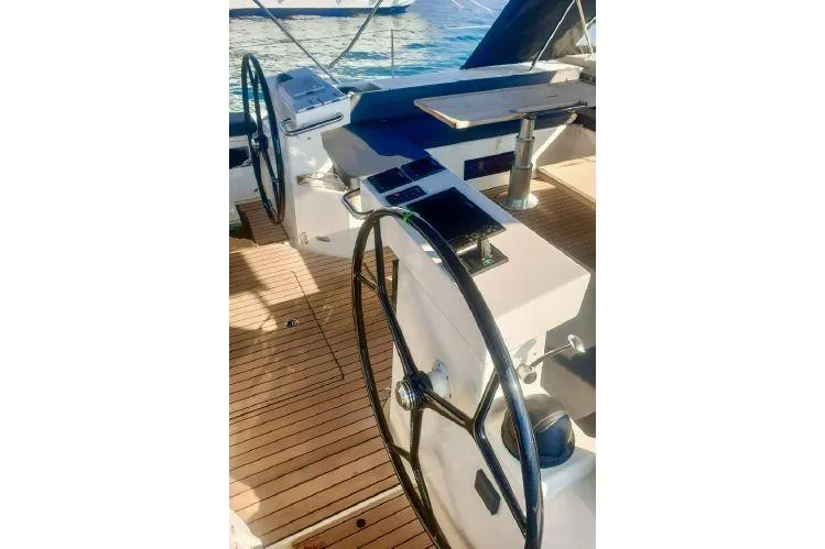  Yacht Photos Pics Bavaria C57 yacht cockpit with dual steering wheels, 2022 model, on teak deck.