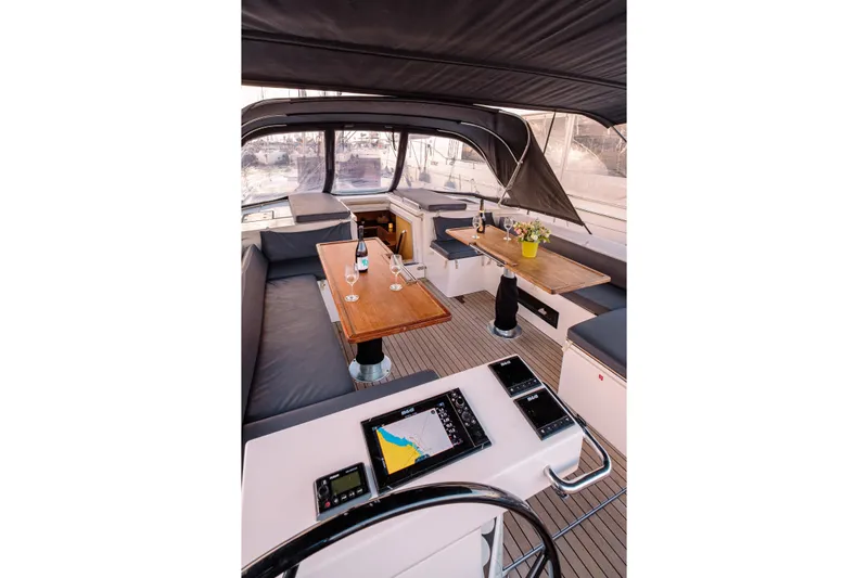  Yacht Photos Pics Luxurious interior of 2022 Bavaria C57 yacht with elegant seating and navigation equipment.
