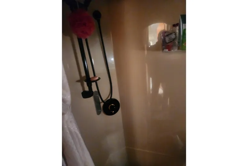 Bella Vita Yacht Photos Pics Shower area inside 2002 Cruisers Yachts 3870 Express, featuring modern fixtures and storage.