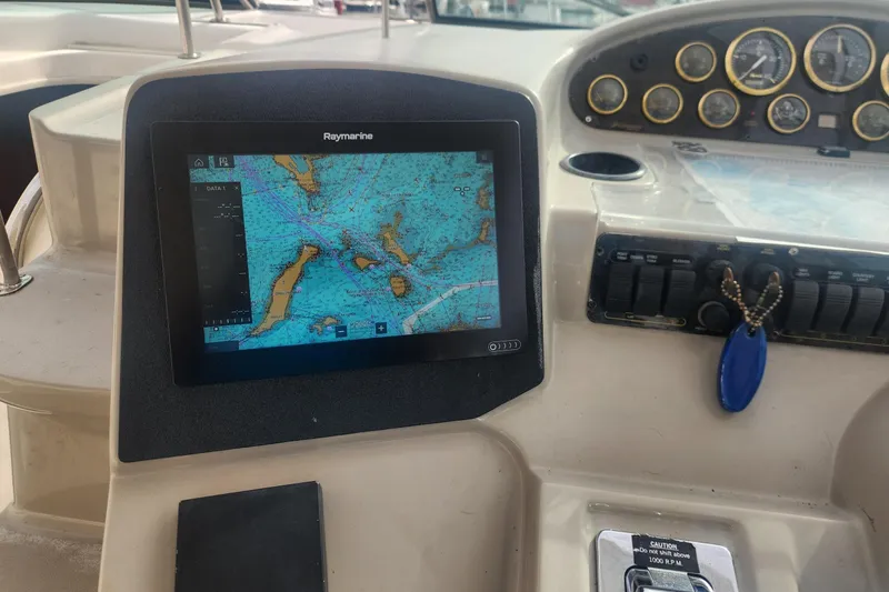 Bella Vita Yacht Photos Pics 2002 Cruisers Yachts 3870 Express dashboard with Raymarine navigation display and gauges.