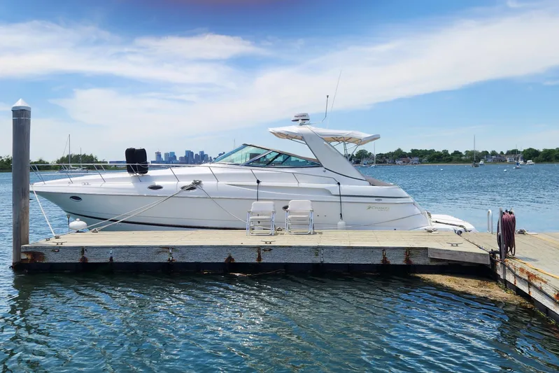 Bella Vita Yacht Photos Pics 2002 Cruisers Yachts 3870 Express docked on a sunny day, with city skyline in background.