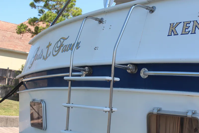 Gods Favor Yacht Photos Pics 1986 DeFever 53 yacht stern with ladder and decorative lettering.