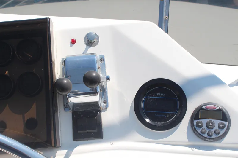 Gods Favor Yacht Photos Pics Control panel of a 1986 DeFever 53 yacht with throttle and depth gauge.