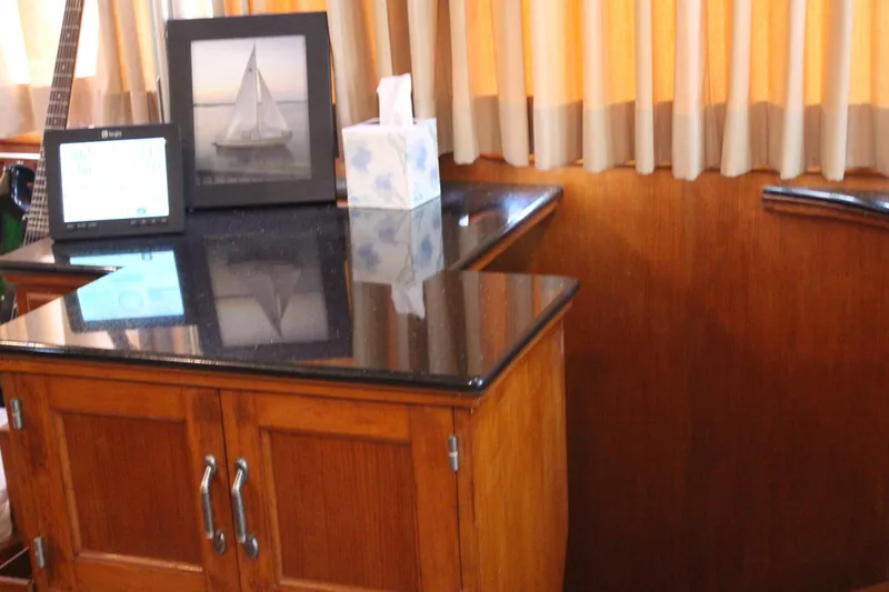 Gods Favor Yacht Photos Pics Interior of 1986 DeFever 53 yacht with wooden cabinetry and black countertop.