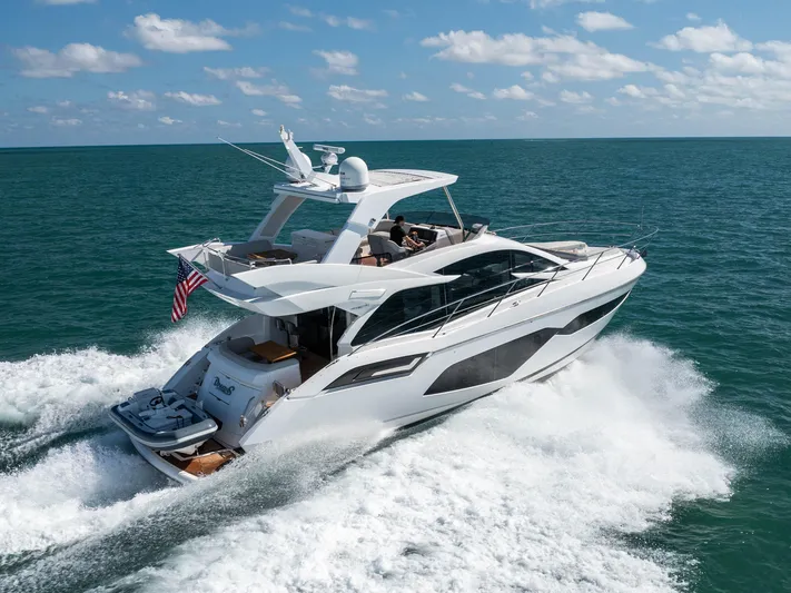 Dreams Yacht Photos Pics 2021 Sunseeker Manhattan 55 yacht cruising on open sea under clear skies.